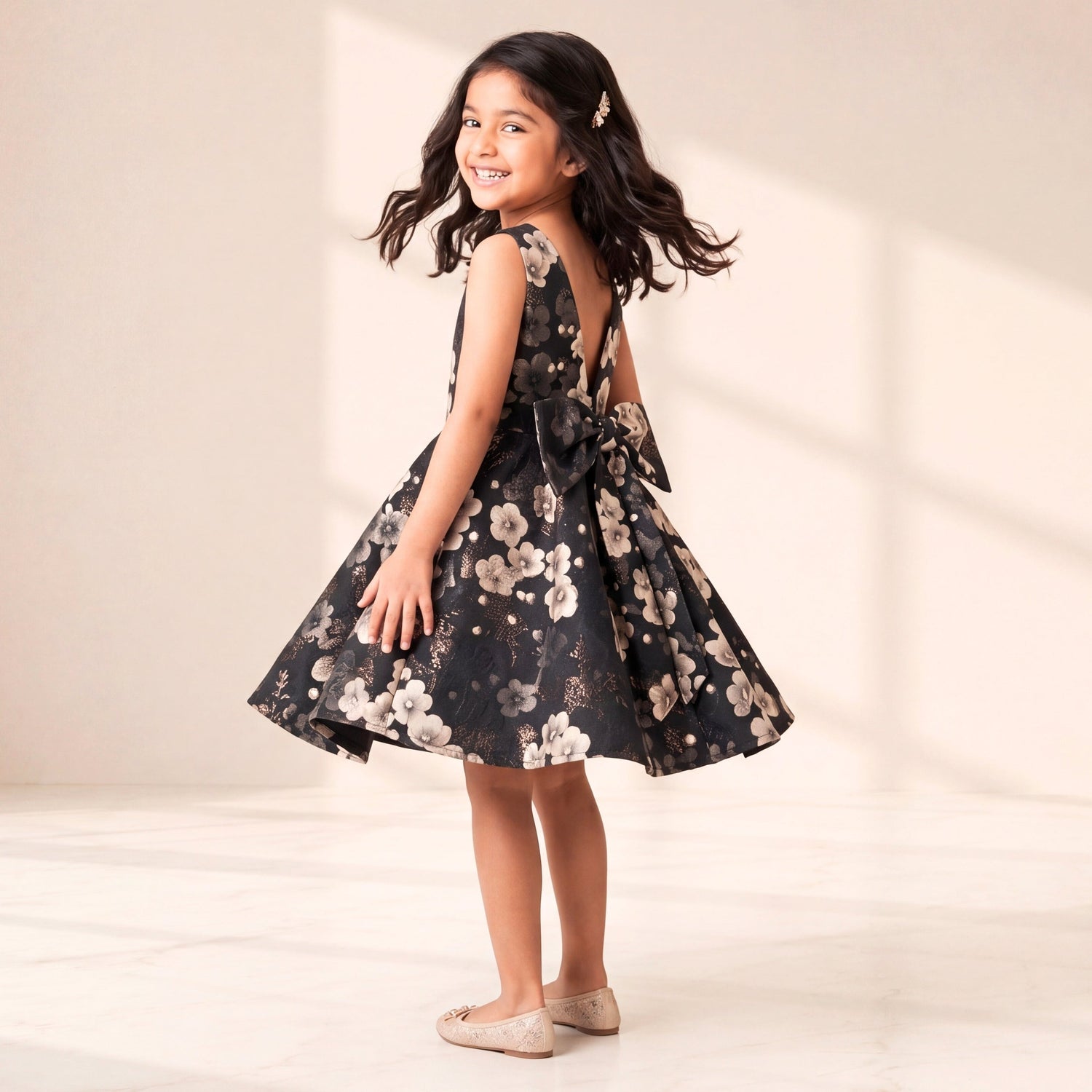 Young girl in a floral dress standing against a plain background