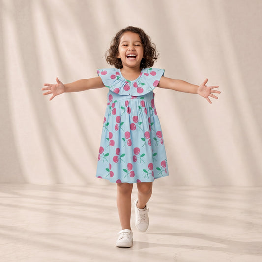 Child wearing a light blue dress with pink floral pattern against a beige background