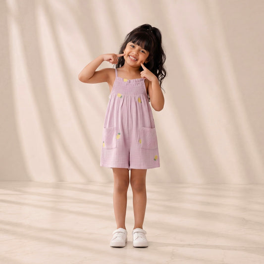 Young girl wearing a pink dress with yellow flowers on a beige background