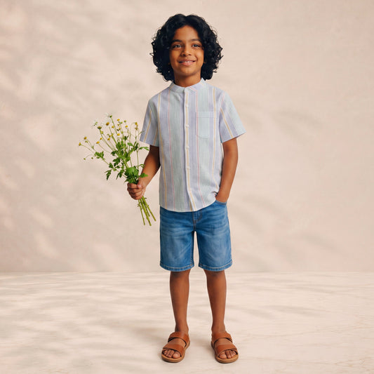 Child holding a bouquet of flowers against a plain background
