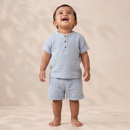 Child wearing a light blue checkered outfit on a beige background