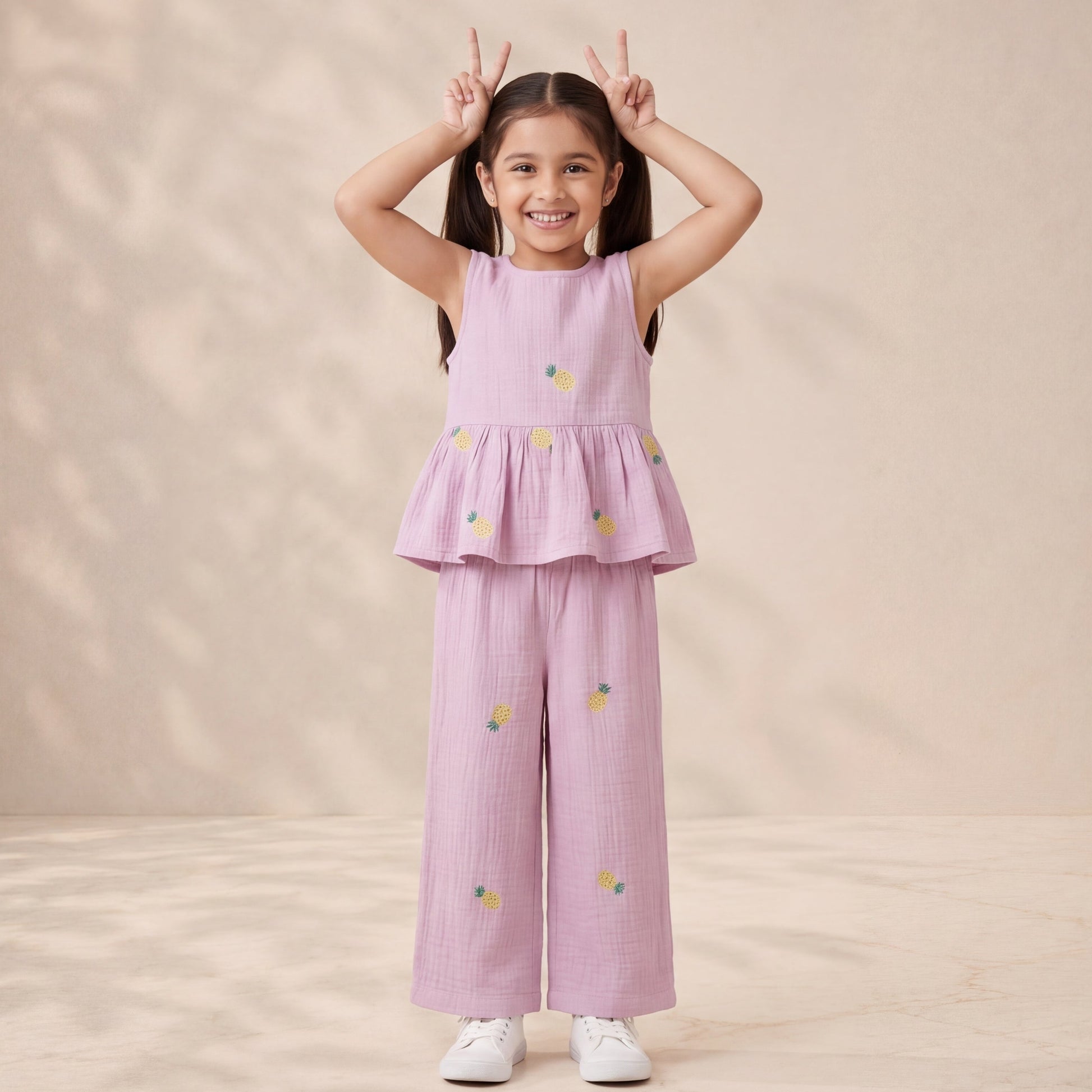 Young girl wearing a pink outfit with floral patterns on a beige background
