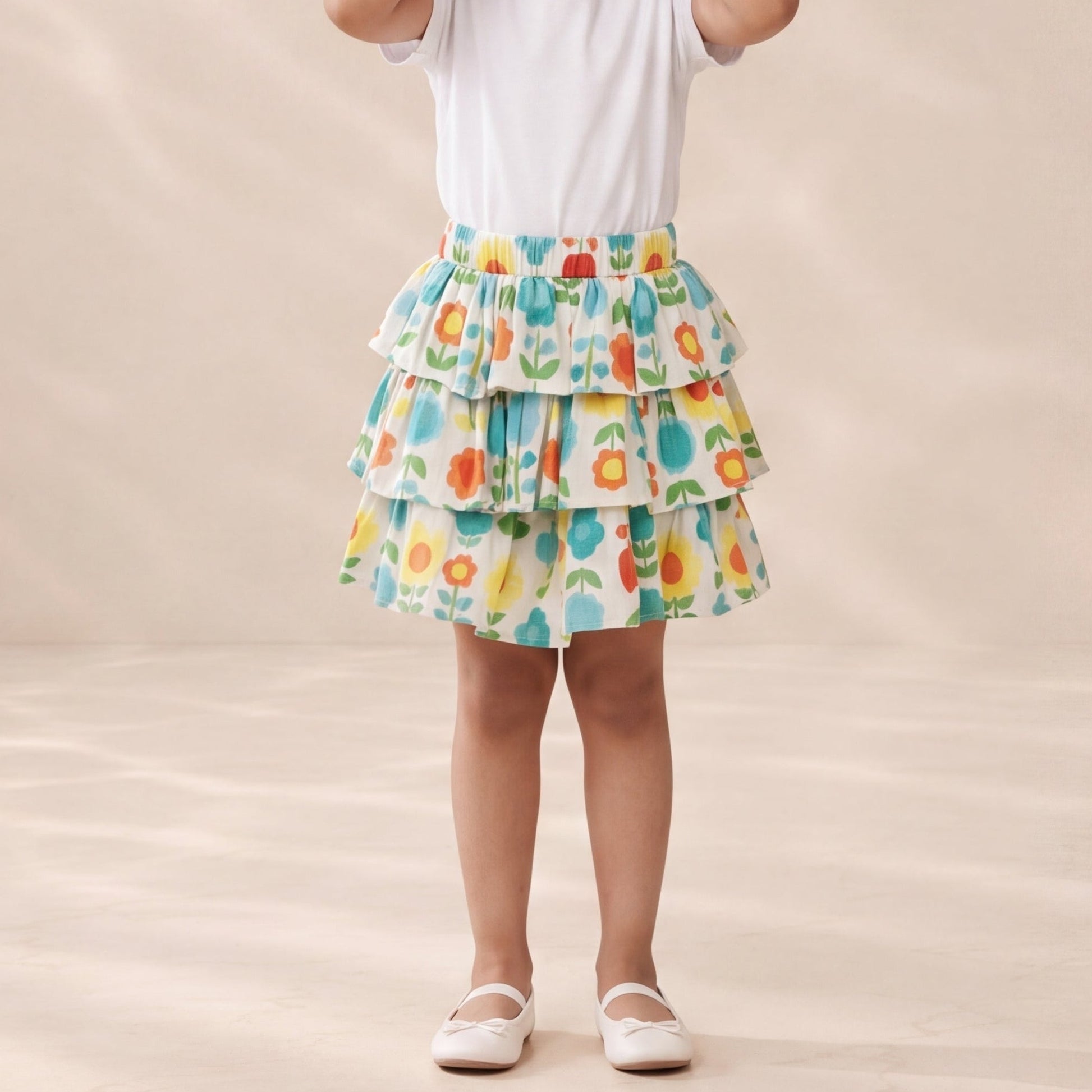 Young girl wearing a colorful skirt and white top on a beige background